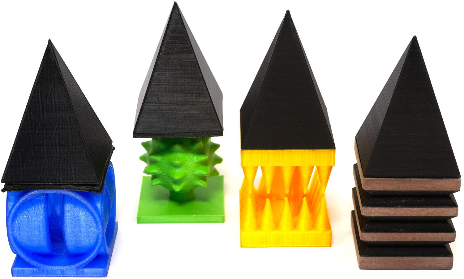 four colourful objects in a row- with black 'hat's on top of them